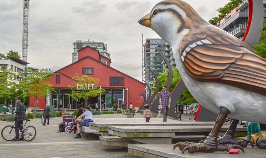 Pedetrians enjoying a park outside a restaurant
