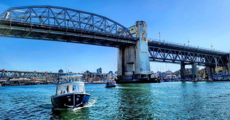 two ferries passing under the Burrard St bridge